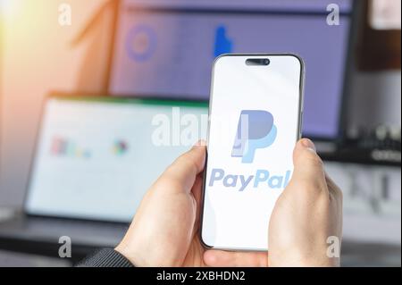 New York, USA - June 6, 2024: Paypal service on smartphone screen in hands close up view on tech background Stock Photo