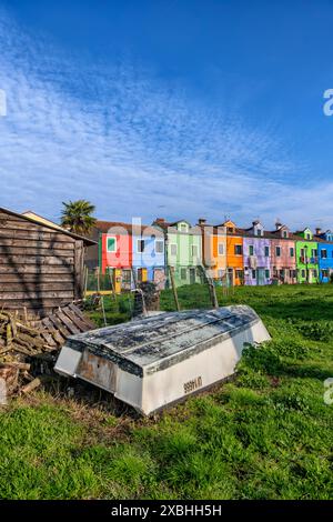 Upside down rowing boat and colorful houses on Burano island in the Venetian Lagoon, Italy. Stock Photo