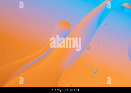 Colorful abstract image with flowing transitions of orange and blue, forming a dynamic and vibrant pattern Stock Photo