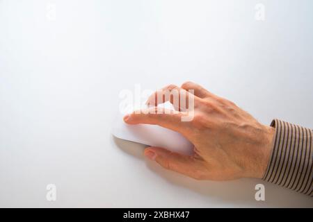 Man's hand using computer mouse. Stock Photo