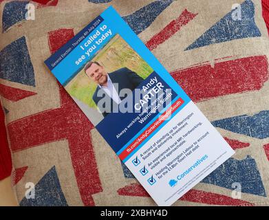 Conservative Tory general election campaign leaflet, on a union flag cushion, in South Warrington, Cheshire, England, WA4 2PL Stock Photo