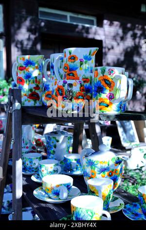 Hand-painted ceramic vessels for sale during a folk fair in the countryside. Stock Photo