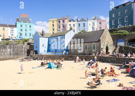 Tenby Harbour and Harbour beach uk backed by Tenby colourful houses and St Julian's Church Tenby Carmarthan bay Pembrokeshire West Wales UK GB Europe Stock Photo