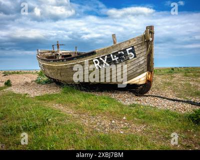 Abandoned weathered old wooden boat on Dungeness beach Stock Photo