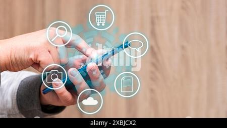 An unrecognizable person is touching a mobile phone's screen and some icons appears surrounding it. Stock Photo