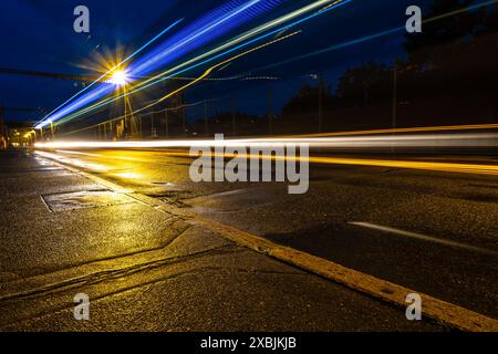 Long exposure shot of the city of Fribourg at night, with light trails in the foreground, shot in Fribourg, Switzerland Stock Photo