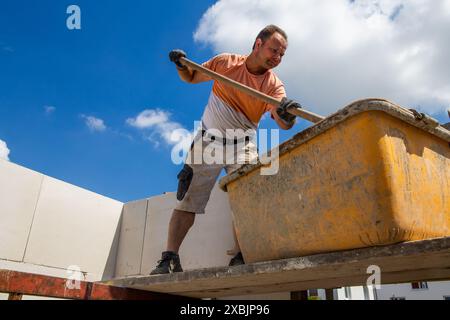 Bricklayer working on the construction site for a new detached house Stock Photo