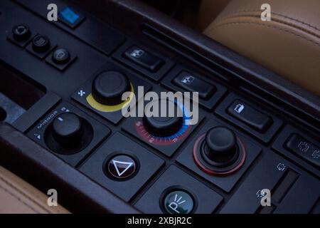 The various buttons and knobs in the center console of a Ferrari Testarrosa. Stock Photo