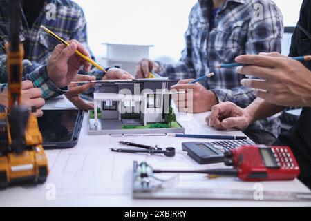engineering is currently discussing structural design issues with architects to review plans to suit construction and stability of building. concept j Stock Photo