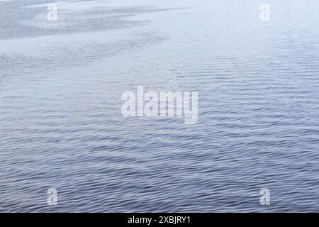 Sparkling blue water with small waves in it Stock Photo