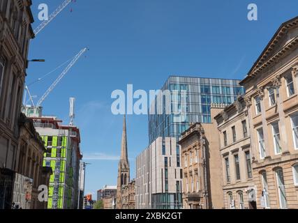 A variety of architectural styles can be seen in Bath Street, Glasgow near Charing Cross.  Construction of student accommodation continues on the left. Stock Photo