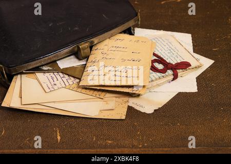 Postal letters in the vintage black handbag Stock Photo
