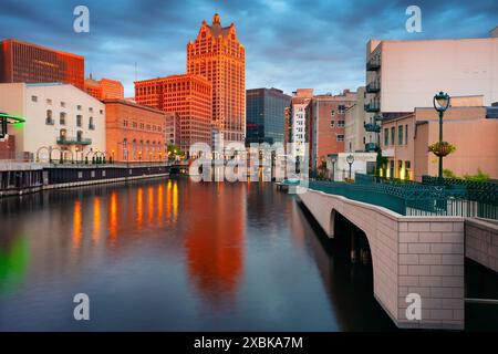 Milwaukee, Wisconsin, USA. Cityscape image of downtown Milwaukee, Wisconsin, USA with reflection of the skyline in Milwaukee River at summer sunset. Stock Photo