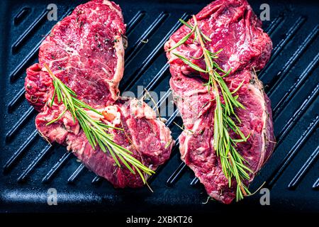 Raw marbled beef steaks with grilled rosemary. Close-up. High quality photo Stock Photo
