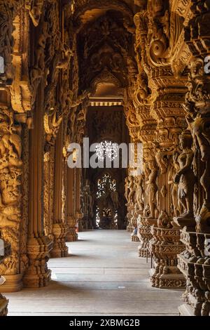 Interior view of a detailed carved wooden temple with ornate corridors, Pattaya, Thailand Stock Photo