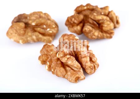 Walnut kernel, Closeup of big shelled walnuts pile. Top view of bunch of nutrient fresh walnuts without shell isolated on white background. Stock Photo