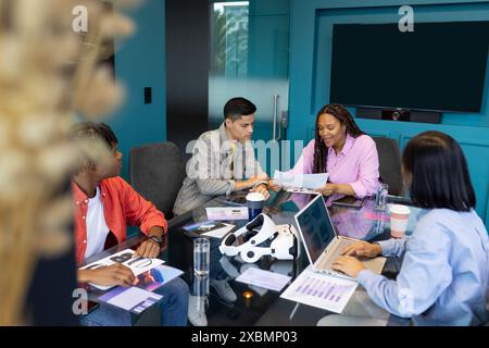 Diverse Business colleagues work together at a table with documents and a laptop during a meeting Stock Photo