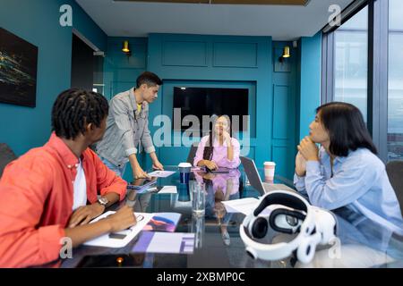 Diverse team meets in modern conference room for business collaboration Stock Photo