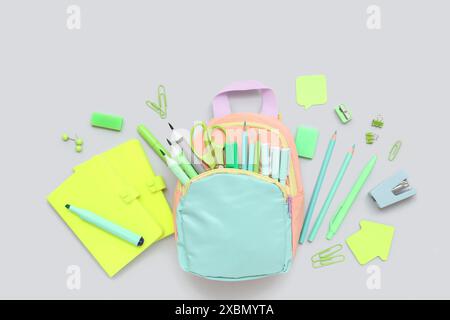 Composition with different stationery and stylish school backpack on grey background Stock Photo