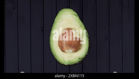 Image of one avocado on black background Stock Photo
