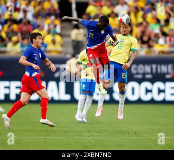 Orlando, Florida, USA. 12th June, 2024. Brazil midfielder JOAO GOMES (15) heads the ball against United States forward TIM WEAH (21) during an international friendly soccer match on June 12, 2024 in Orlando, Florida. The match finished a 1-1 draw. (Credit Image: © Scott Coleman/ZUMA Press Wire) EDITORIAL USAGE ONLY! Not for Commercial USAGE! Stock Photo