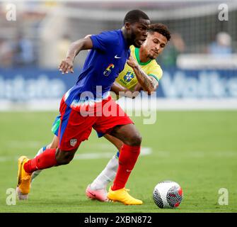 Orlando, Florida, USA. 12th June, 2024. United States midfielder YUNUS MUSAH (6) works against Brazil midfielder JOAO GOMES (15) during an international friendly soccer match on June 12, 2024 in Orlando, Florida. The match finished a 1-1 draw. (Credit Image: © Scott Coleman/ZUMA Press Wire) EDITORIAL USAGE ONLY! Not for Commercial USAGE! Stock Photo