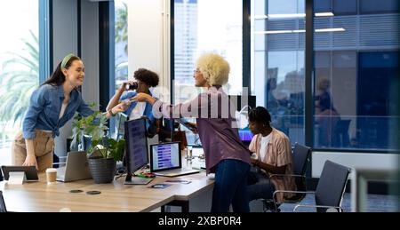 Diverse colleagues collaborating in modern office for a business start-up Stock Photo