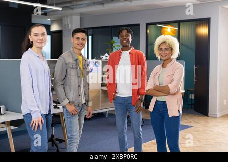 Diverse Business colleagues standing together in a modern office, showcasing teamwork Stock Photo
