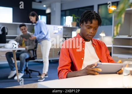African american man using tablet at his business desk Stock Photo