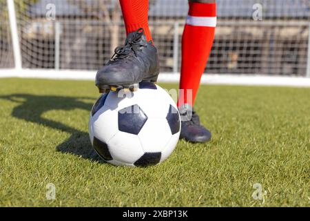 African American athlete training with soccer ball on a field Stock Photo