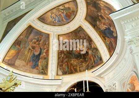 Frescoes depicting scenes from the life of jesus christ decorating the ceiling of a church, showcasing religious art and spirituality Stock Photo