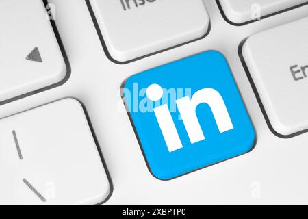 LinkedIn icon key on white computer keyboard close-up. Concept of process in popular social media services. LinkedIn is a business social media platfo Stock Photo