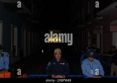 San Juan, USA. 12th June, 2024. Police watch protesters picket following a blackout outside La Fortaleza in Old San Juan, Puerto Rico on Thursday, June 12, 2024. Nearly a third of Puerto Ricans lost power earlier in the night, mostly in the capital city of San Juan. Blackouts have become a common experience after Hurricane Maria in 2017 because the grid was never properly rebuilt. (Photo by Carlos Berríos Polanco/Sipa USA) Credit: Sipa USA/Alamy Live News Stock Photo