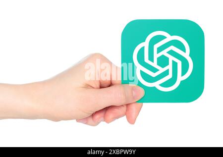 Hand holds paper OpenAI ChatGPT mobile app icon, on a transparent ...