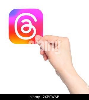 Hand holds paper Threads mobile app icon, on a transparent background ...