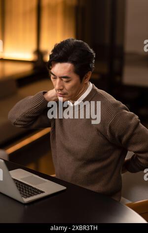 Stressed Out Businessman Rubbing His Neck Stock Photo