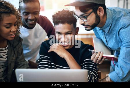 Students, e learning and laptop for university as group in college or school in class for assignment. Teamwork, people and collaboration with reading Stock Photo