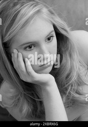 Pensive Caucasian teen girl looking thoughtful, USA. Stock Photo