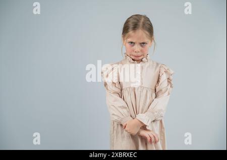 Portrait of a dissatisfied Caucasian girl on a white background.  Stock Photo