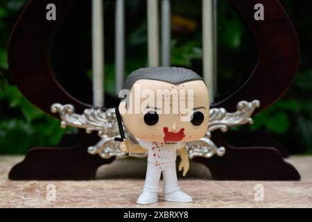 Funko Pop action figure of Hannibal Lecter from popular horror movie Silence of the Lambs. Toy standing against vintage miniature jail bars. Stock Photo