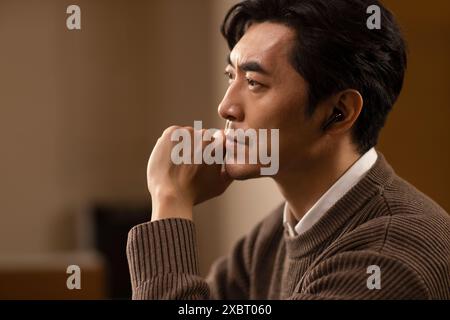 Mature Man Using Cordless Earbuds Stock Photo