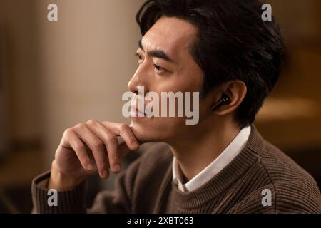 Mature Man Using Cordless Earbuds Stock Photo