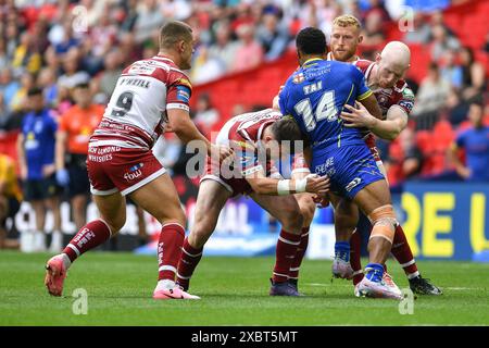 London, England - 8th June 2024 - Rodrick tai of Warrington Wolves tackled by Harry Smith of Wigan Warriors and Liam Farrell of Wigan Warriors.  Rugby League Betfred Challenge Cup Final, Warrington Wolves vs Wigan Warriors at Wembley Stadium, London, UK  Dean Williams Stock Photo