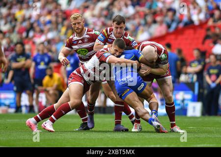 London, England - 8th June 2024 - Rodrick tai of Warrington Wolves tackled by Brad O'Niell of Wigan Warriors, Harry Smith of Wigan Warriors and Liam Farrell of Wigan Warriors.  Rugby League Betfred Challenge Cup Final, Warrington Wolves vs Wigan Warriors at Wembley Stadium, London, UK  Dean Williams Stock Photo