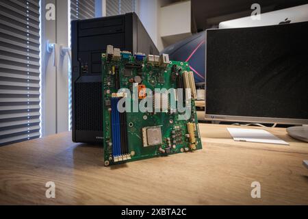 a computer mainboard is examined with a magnifying glass Stock Photo