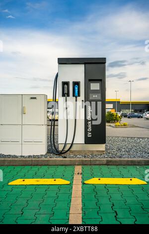 Supercharger for electrical or hybrid PHEV automobiles at public parking Stock Photo