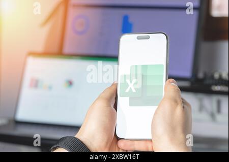 New York, USA - June 6, 2024: Microsoft excel  service on smartphone screen in hands close up view on tech background Stock Photo