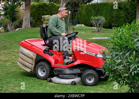 Mowing the lawn, ride on power mower Stock Photo