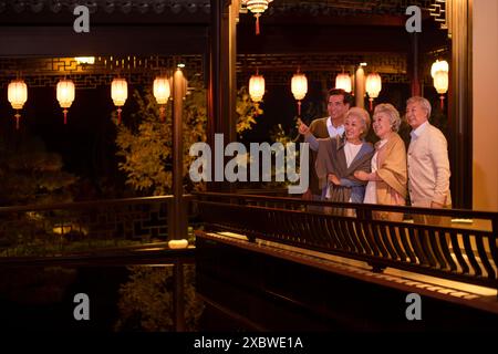 Senior Friends in a Park at Dusk Stock Photo
