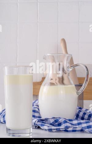 Non-Homogenized, whole milk, cream-top layered dairy product, Creamline Milk concept. Organic farm natural, unpasteurized milk in glass and jug, on wh Stock Photo